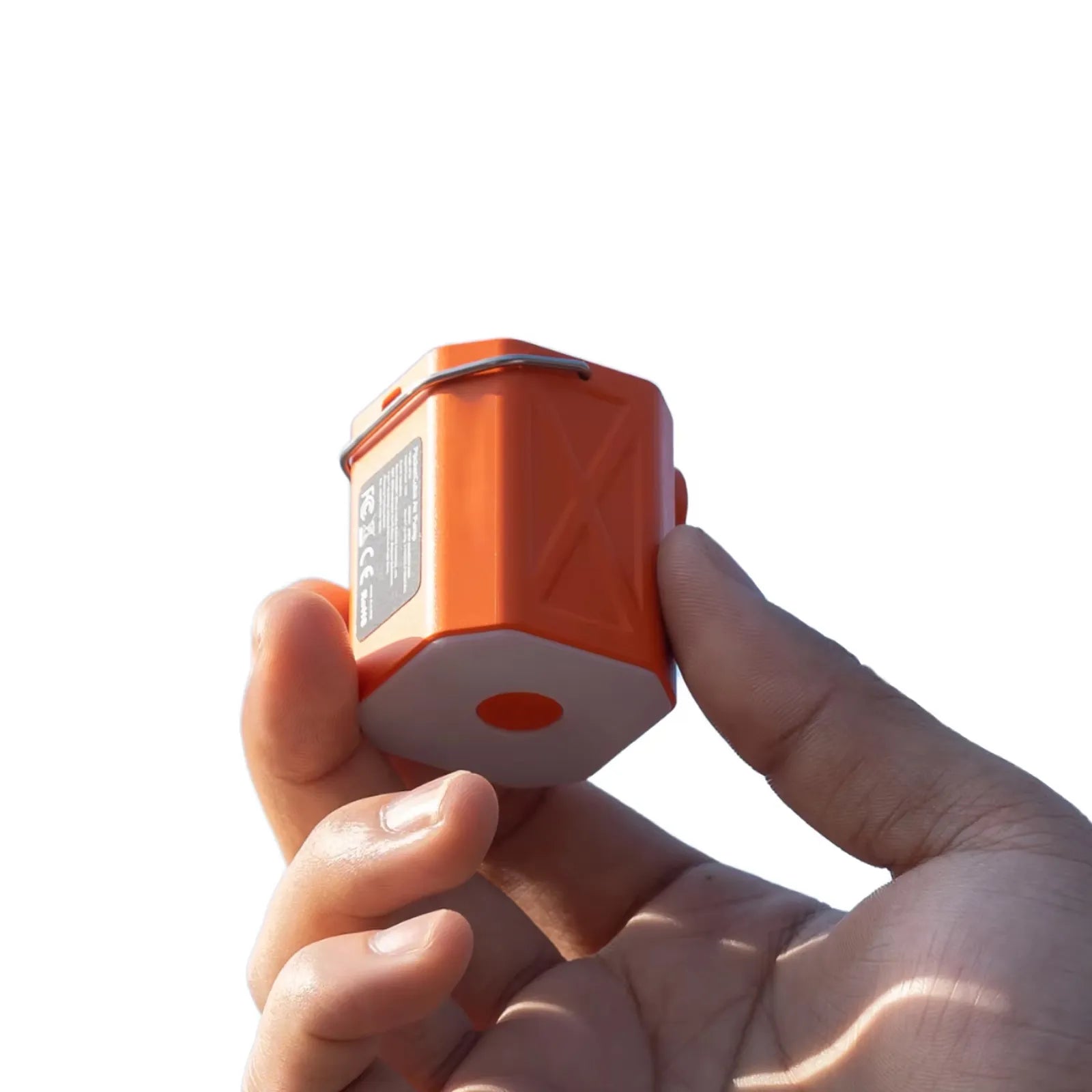Hand holding the ROOS CAMP ultra-portable mini air pump, showcasing its compact hexagonal design and lightweight build for outdoor camping.
