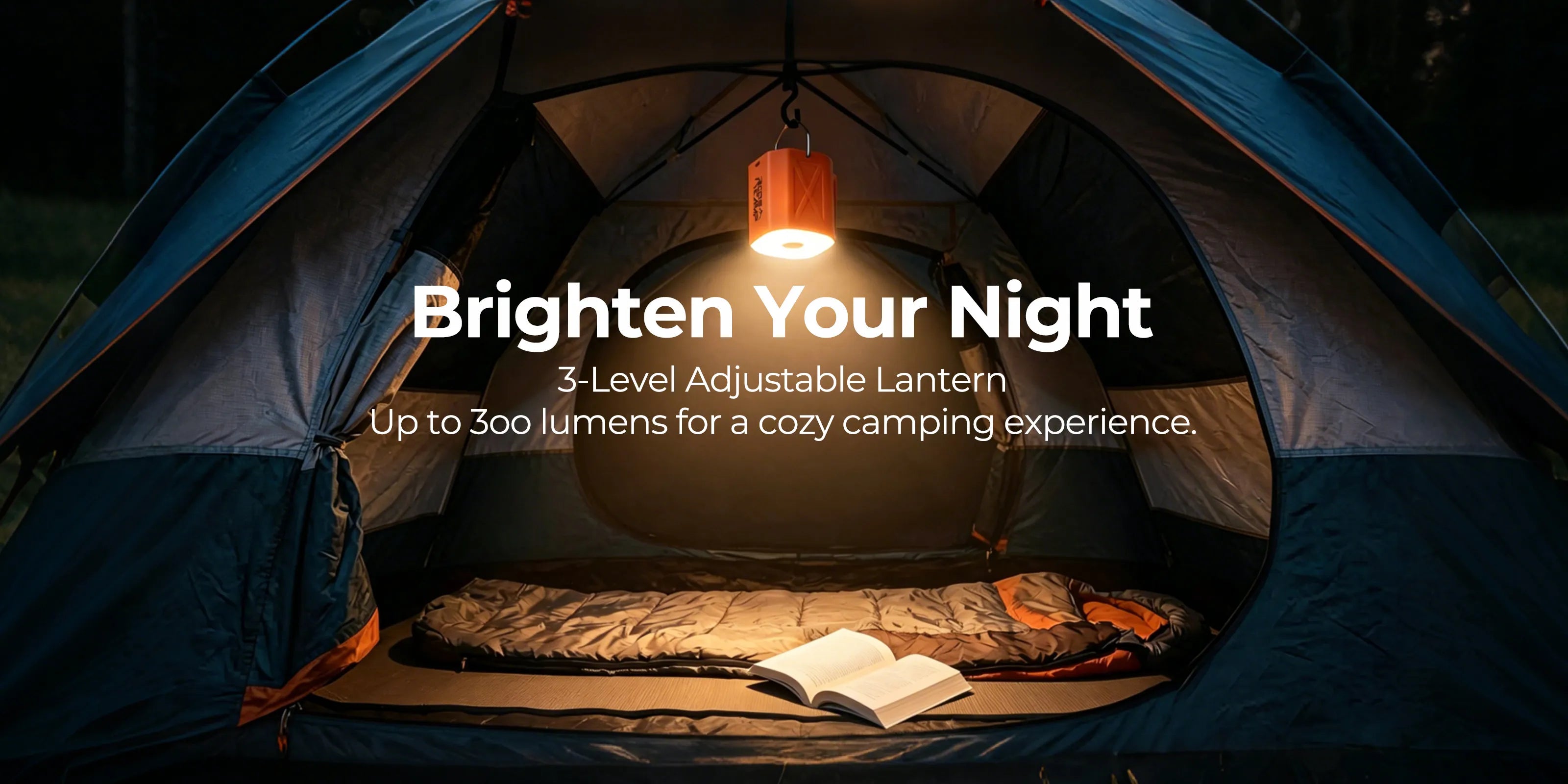 Roos Camp 3-level adjustable LED lantern hanging inside a dark camping tent, casting a warm glow over a sleeping bag and book.